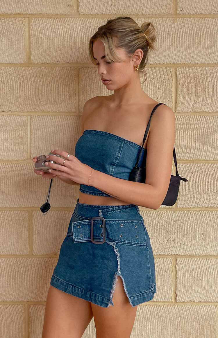 Beginning Boutique Elouise Buckle Denim Mini Skirt blue denim fitted mini skirt with buckle detail distressed hem and front split