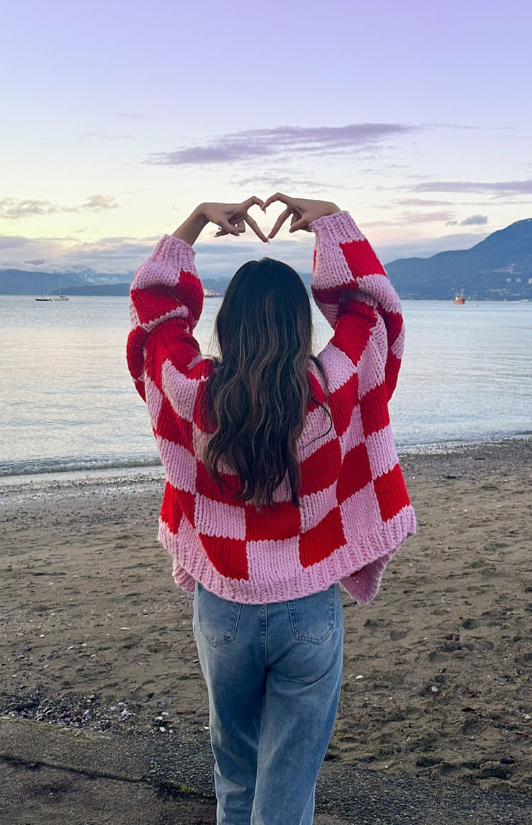 Back view of the oversized pink and red checkered knit cardigan showing the chunky texture