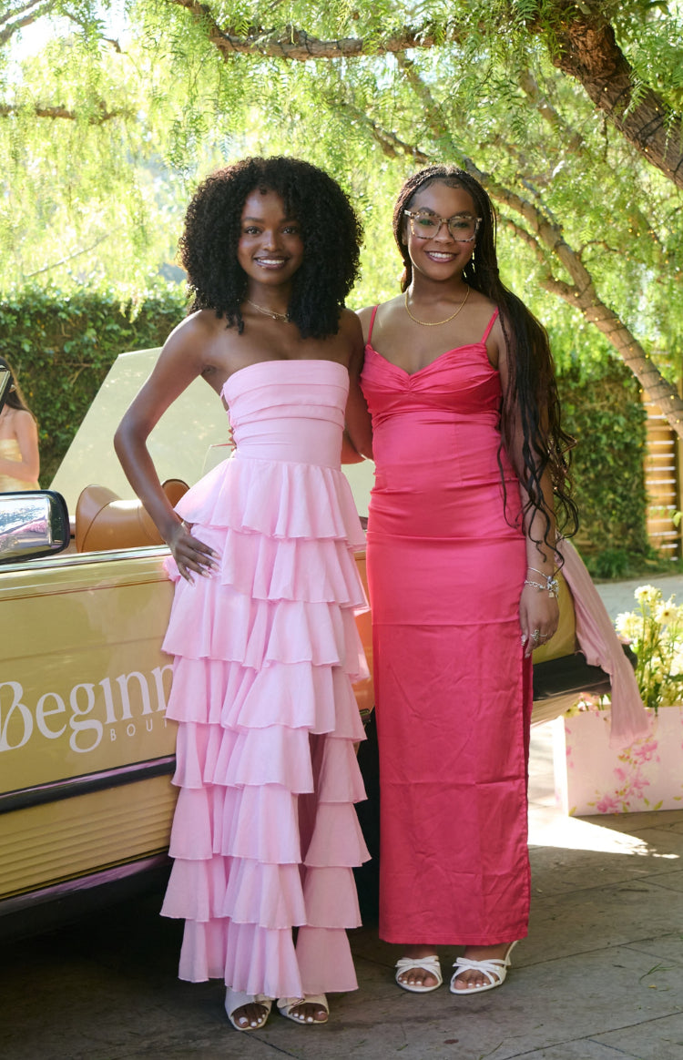 Full length view of a light pink strapless maxi dress with multiple tiers of ruffles from the bust to the hem