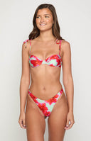 model wearing green and red balconette floral bikini top and bottoms with gold jewellery