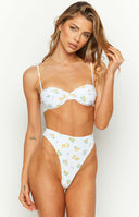 Front view of white high-waisted bikini bottoms with small yellow and purple floral print and high-cut leg