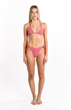 Our model wearing a simple string triangle bikini top is featured with a pattern of thin horizontal stripes in bright red and white. It has thin red string halter ties and an adjustable band at the bottom. The fit is minimal and traditional.