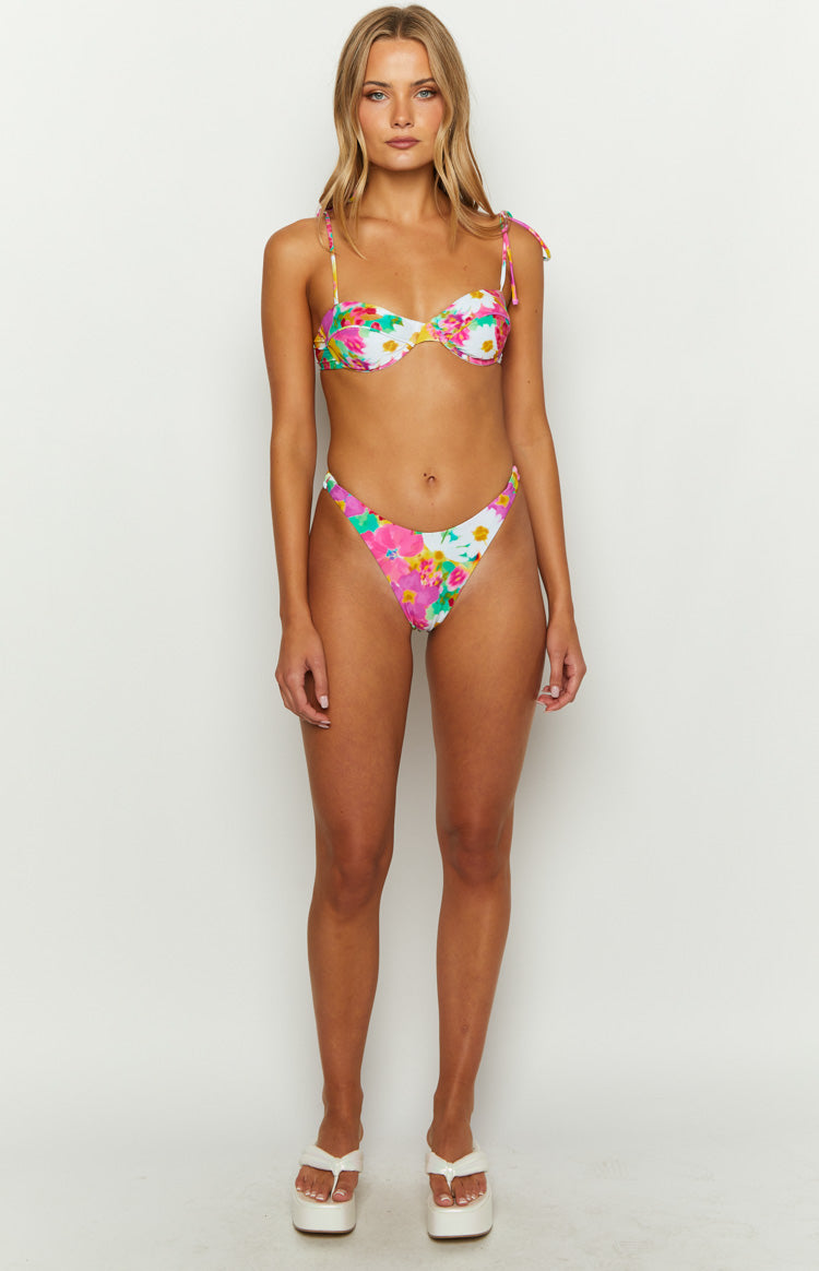 White floral bikini top with pink and green flowers, underwire cups, and adjustable tie shoulder straps