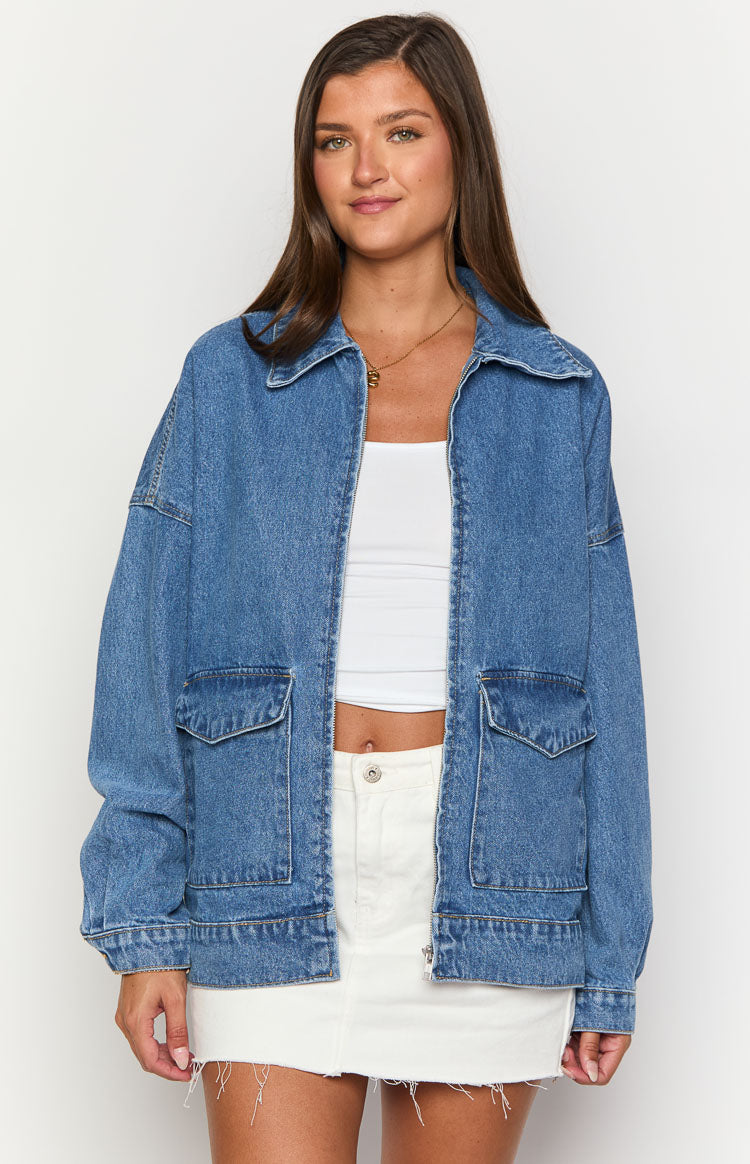 Mid wash denim bomber jacket with a collared neckline, unzipped front, and two chest flap pockets