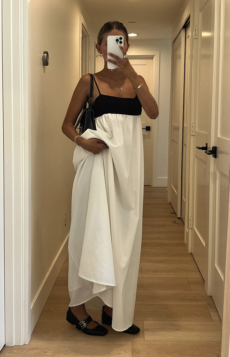 Front view of the black square neck bodice and the full, flowing white skirt of the contrast maxi dress