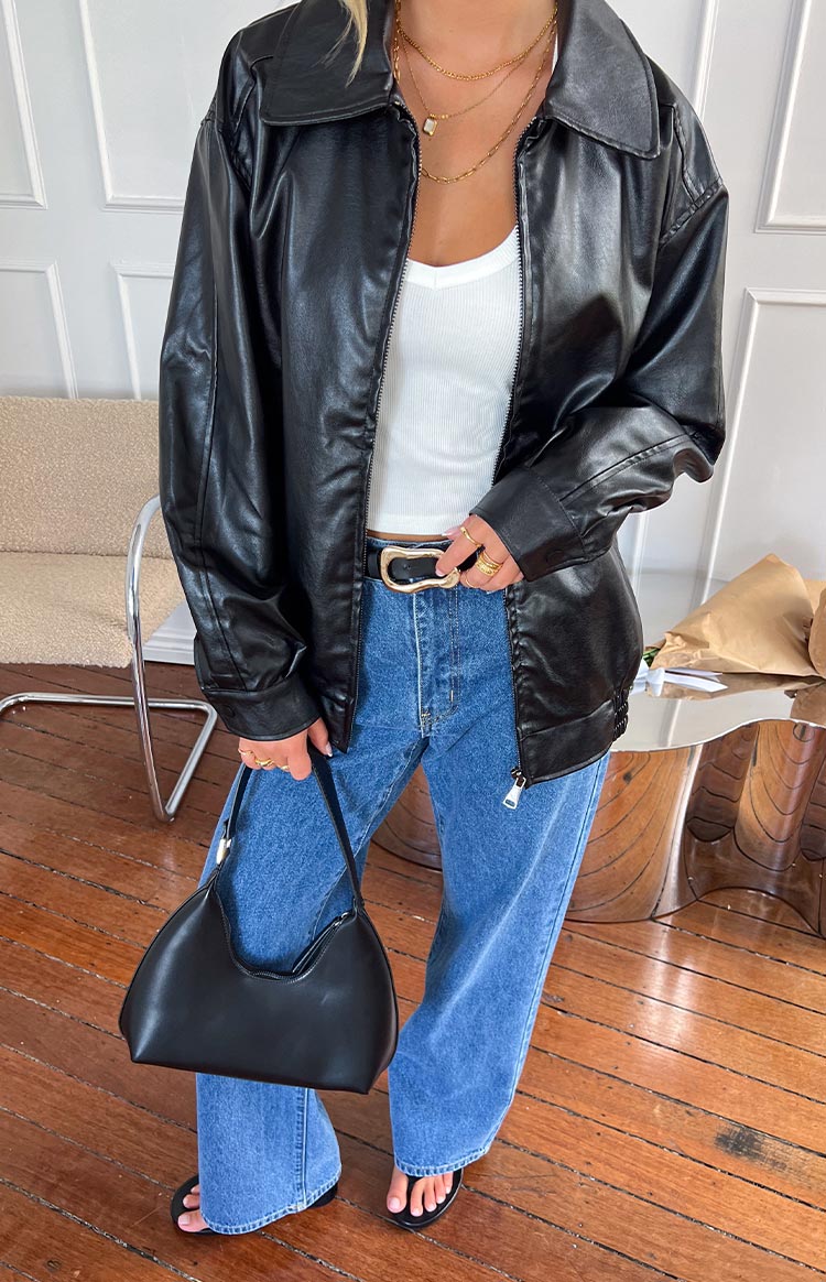 Black PU bomber jacket with an oversized relaxed fit, wide collar, and partially unzipped front