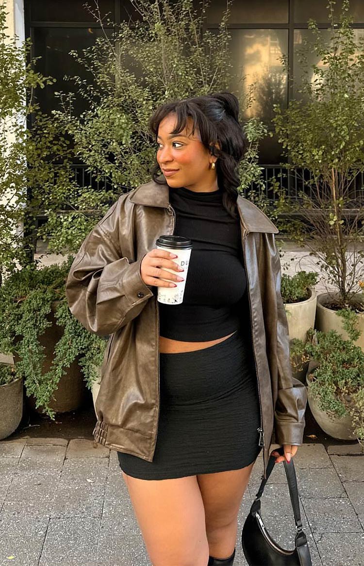 Front view of a vintage brown PU bomber jacket with a wide pointed collar and relaxed fit