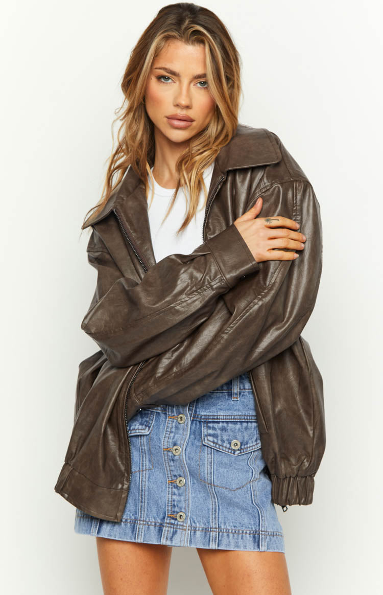 Front view of an oversized vintage brown PU bomber jacket with a wide collar and relaxed fit