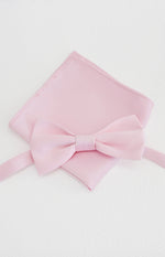 Close-up flat lay of a soft pink bow tie with a matching neatly folded pocket square