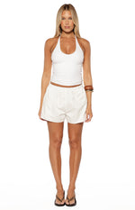 White floral eyelet shorts with an elasticated waist and scalloped hem