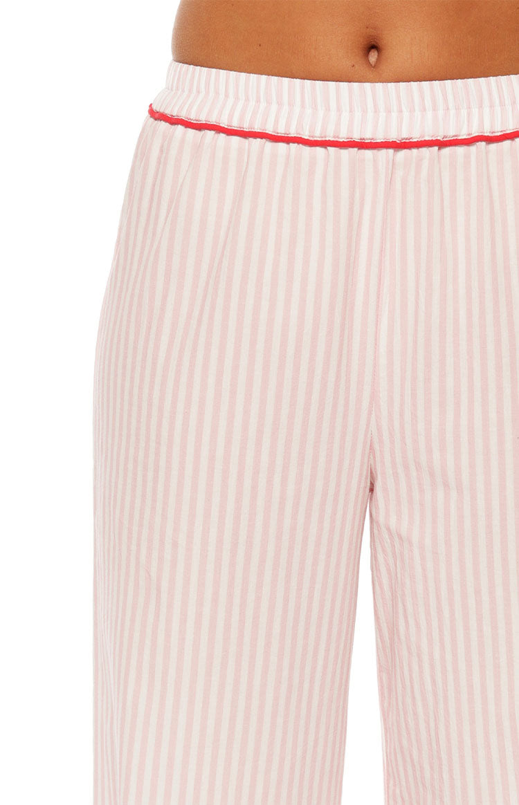 Close-up showing the elasticated waistband and red piping detail on pink stripe pajama pants