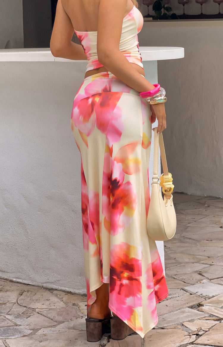 Side view of the yellow and pink floral print maxi skirt, showing the fitted silhouette and hanky hem