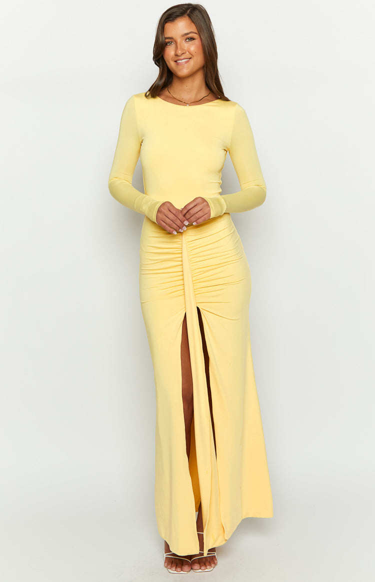 Yellow long sleeve maxi dress with a wide boat neck and ruched front slit