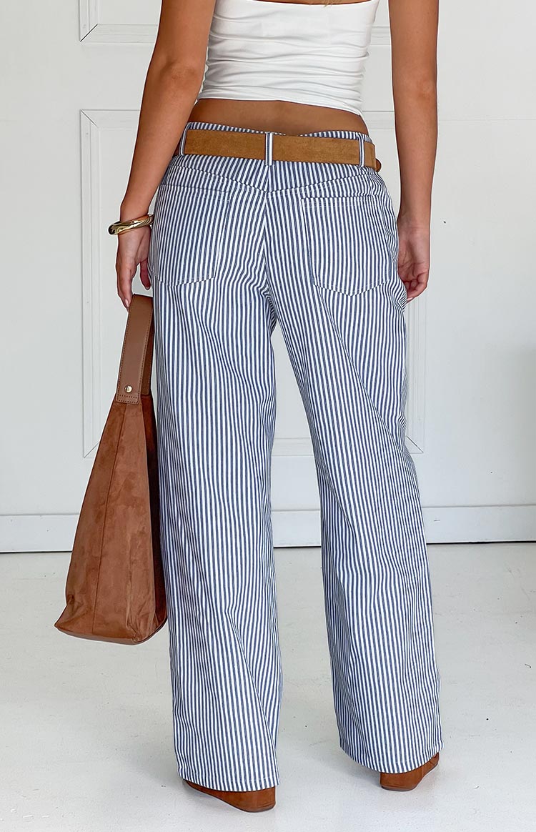 Rear view of navy and white striped straight leg jeans with back patch pockets and a mid-rise waist