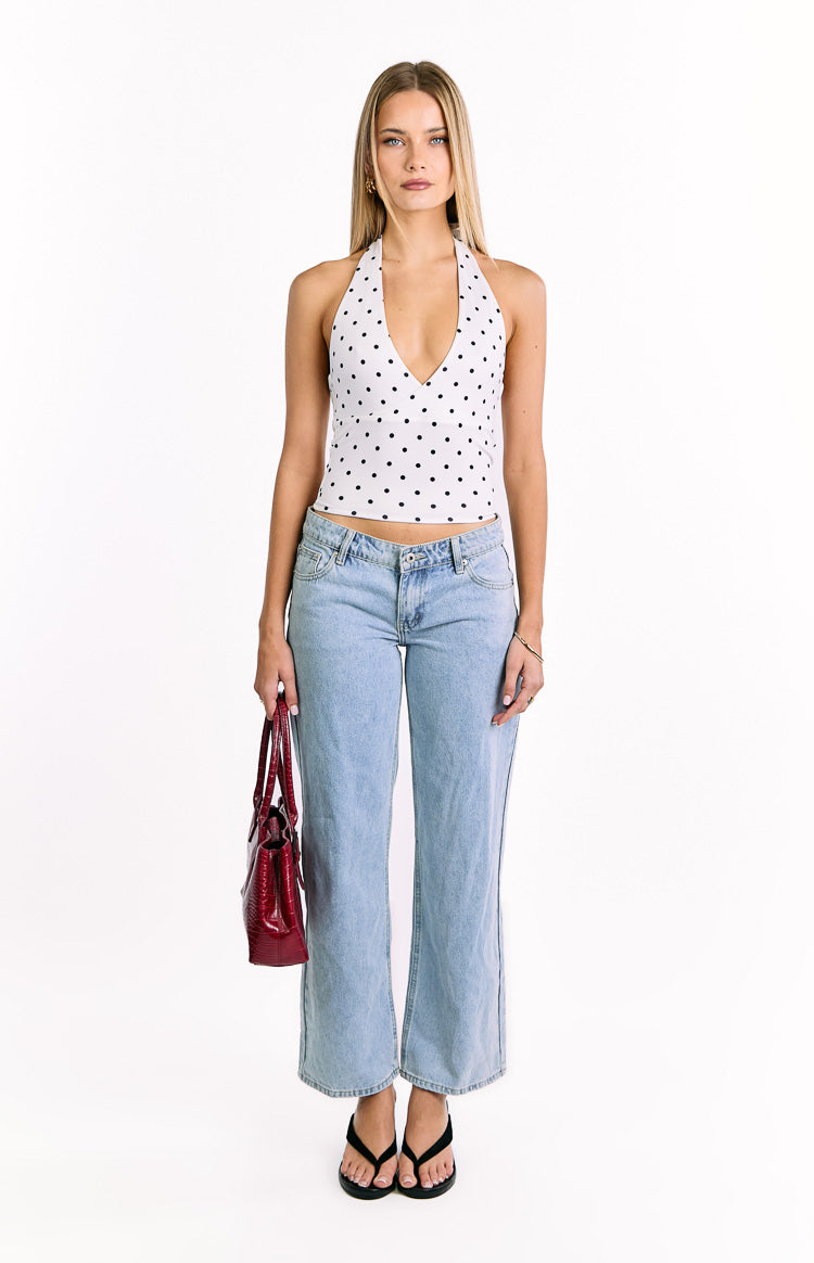 White polka dot crop top with a deep V-neck halter and fitted cropped silhouette