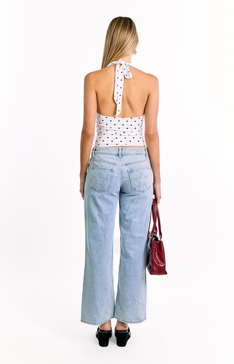 Rear view of the white polka dot crop top featuring a tie-back halter neck