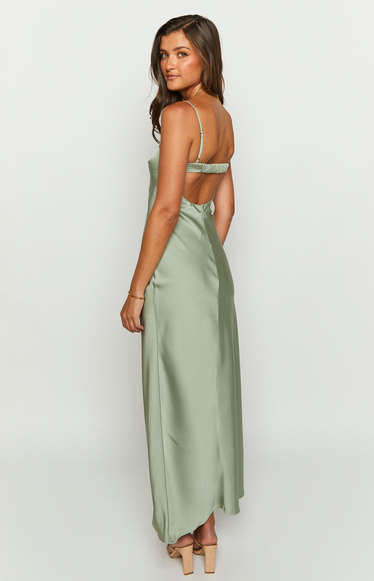 Side view of a sage satin maxi dress showing the low scoop back and ruched elastic strap detail