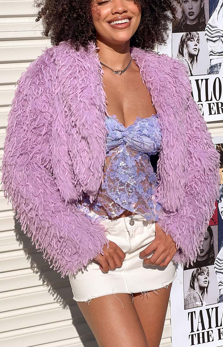 Close-up of the shaggy purple fringe jacket, highlighting the textured material and open front