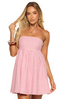 Girl wearing a breezy red and white striped strapless mini dress with a floaty skirt essential for a Summer vacation or beach trip