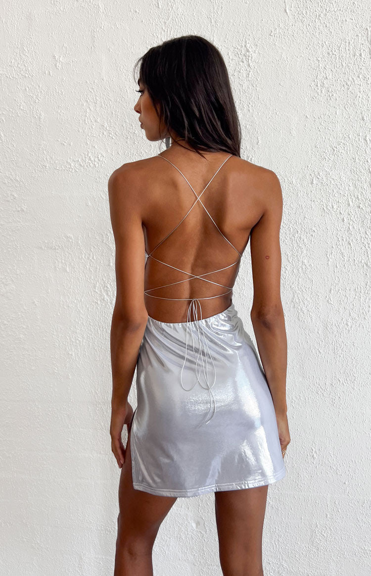 Rear view of a silver metallic mini dress with criss-cross tie-back spaghetti straps and an open back
