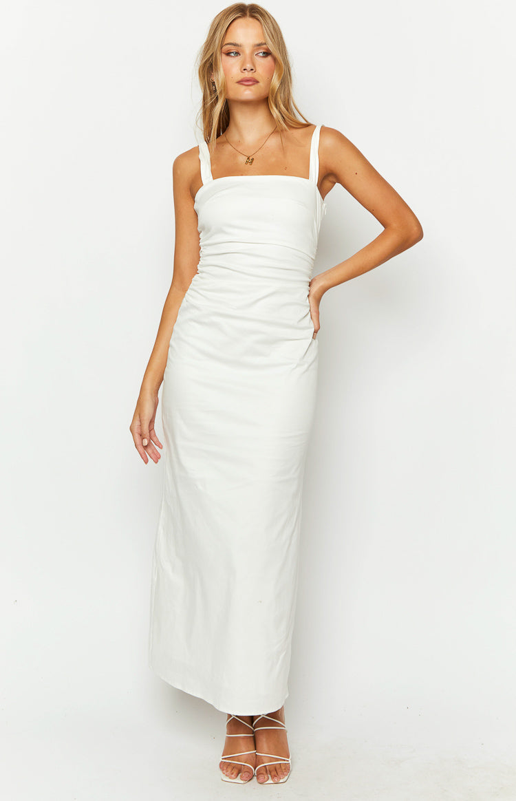 White maxi dress with a square neckline, wide ruched shoulder straps, and ruched side detailing on the bodice