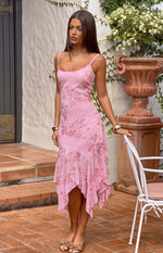 Pink sequin midi dress with scoop neck, spaghetti straps, and a flowy handkerchief hem