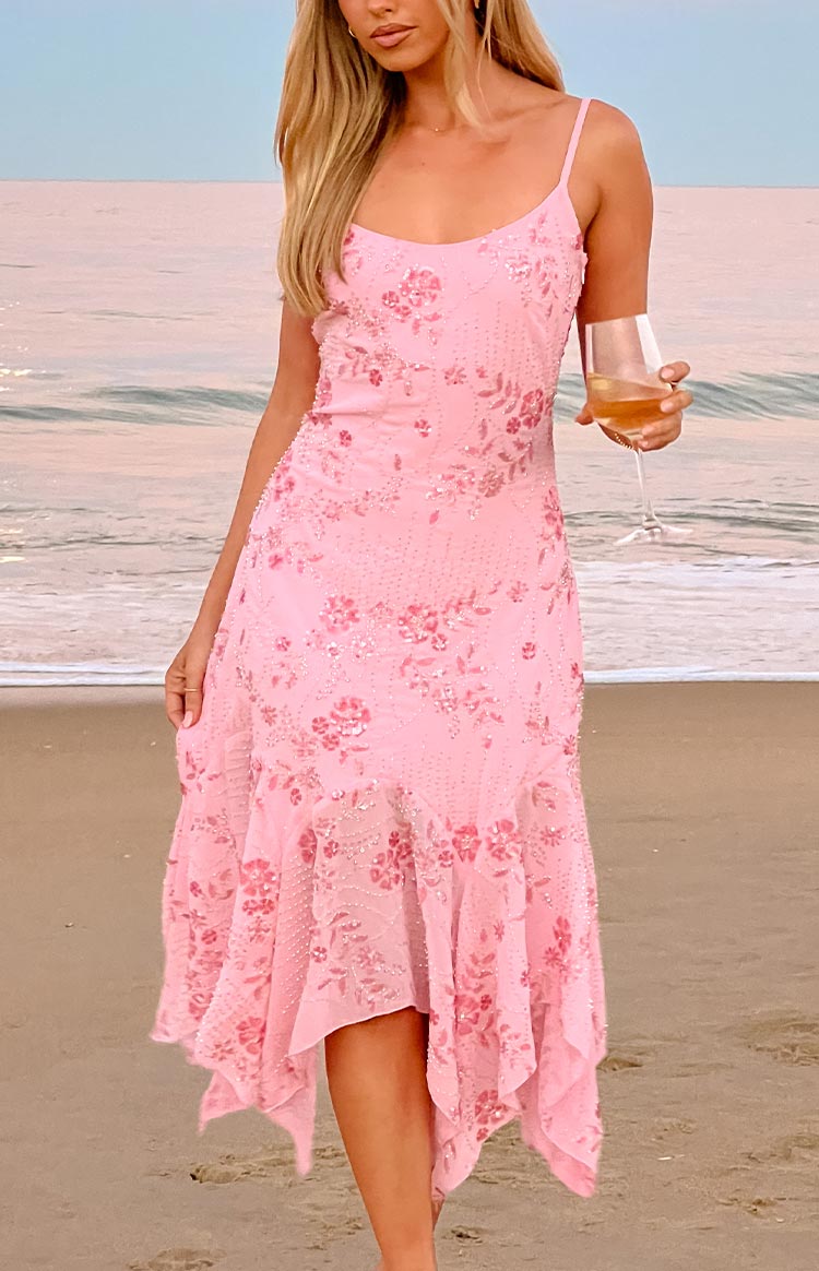 Pink sequin midi dress with spaghetti straps, V-neck, and a flowy handkerchief hem