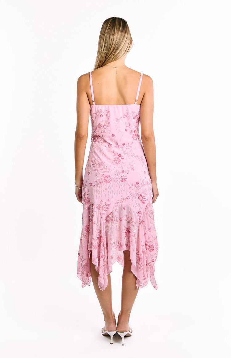 Back view of a pink sequin midi dress with thin straps, square back, floral sequin pattern, and a ruffled handkerchief hem