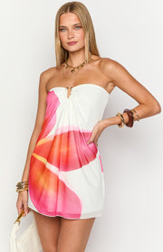Front view of a white strapless mini dress with a gold O-ring bust detail and pink orange floral print