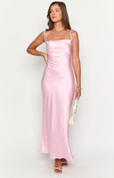 blonde model wearing a pink satin cowl neck formal dress with nude heels and silver jewellery