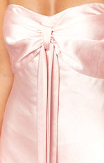 Close-up of the gathered and tied knot detail at the bust of a pink satin maxi dress