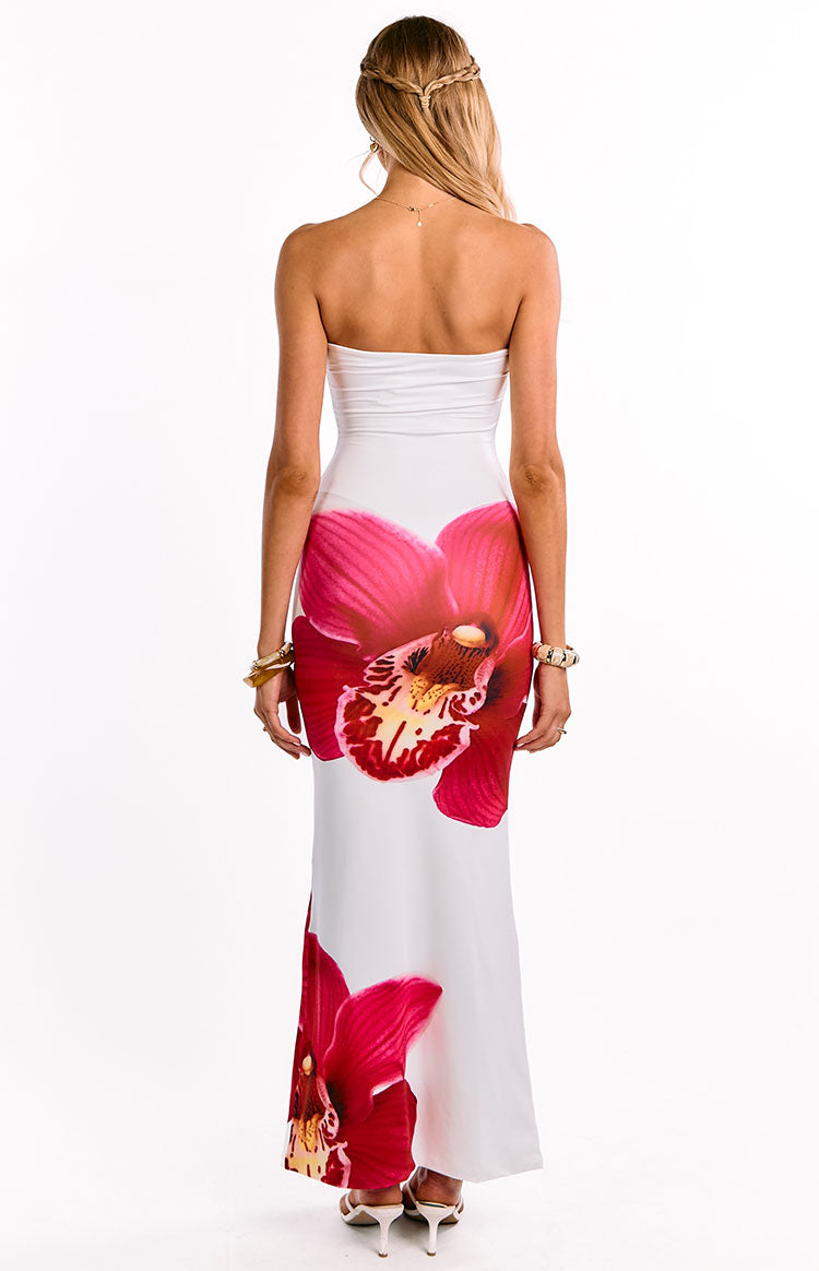 Back view of a white strapless maxi dress with a ruched bandeau top and large pink orchid print
