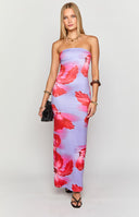 Model wearing a strapless blue maxi dress with a red floral design paired with gold jewellery