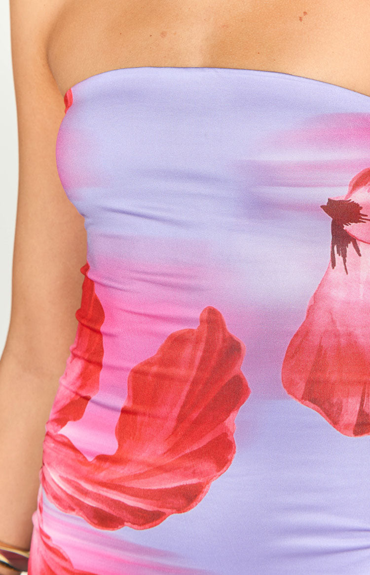 Close-up of the strapless neckline and side ruching of a purple and pink floral print maxi dress
