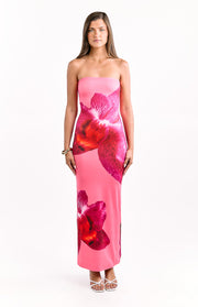 Front view of a pink strapless maxi dress with a large, vibrant red and fuchsia orchid print