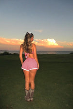 Rear view of red gingham broderie lace shorts with white scalloped trim and elasticated back