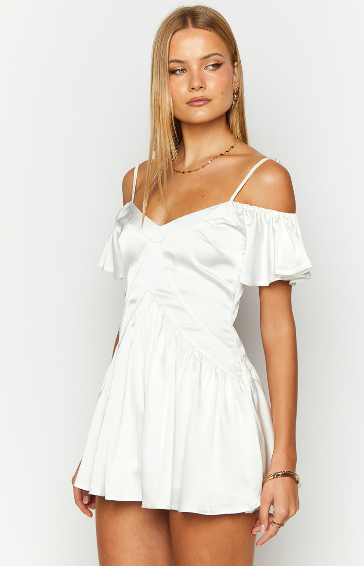White satin playsuit with a V-neckline, off-shoulder flutter sleeves, and ruched bodice detailing