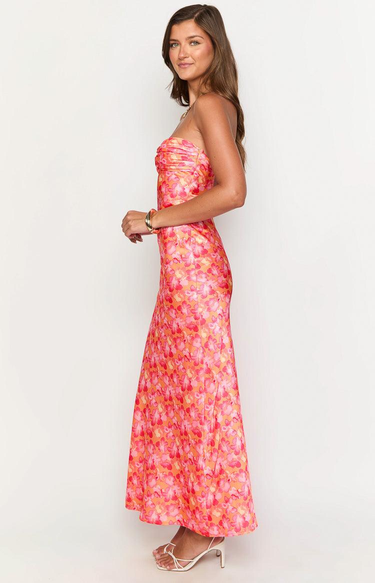Side view of a pink and orange floral strapless maxi dress with a ruched bust