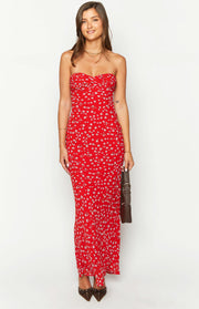 Front view of a red floral strapless maxi dress with a ruched sweetheart neckline and a fitted silhouette