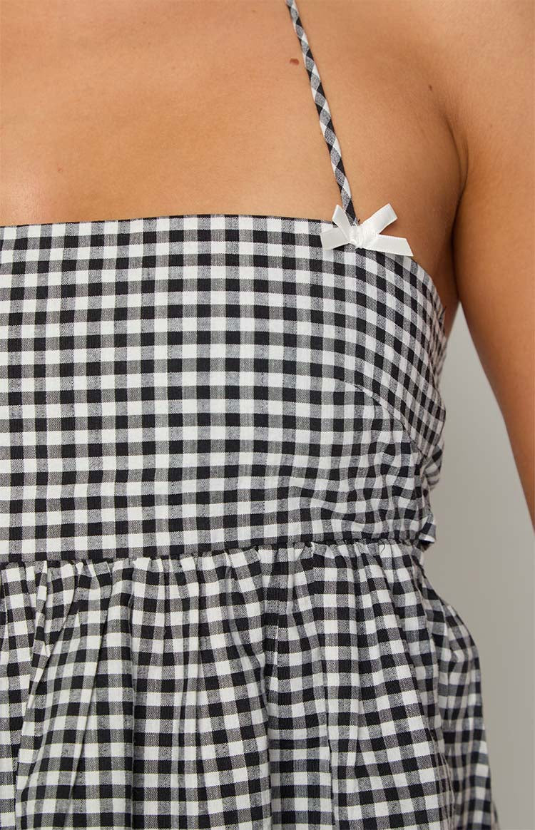 Close-up of the black gingham halter top showing the white bow detail on the strap and elasticated waist