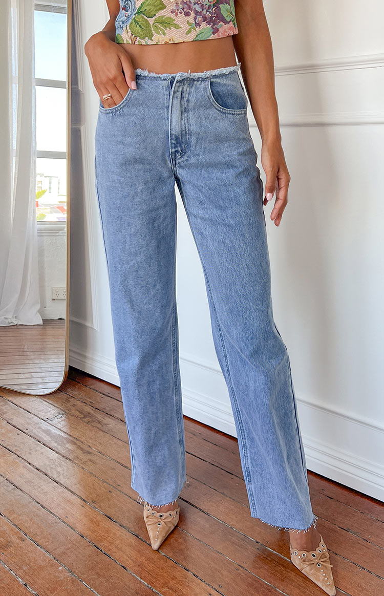 Beginning Boutique Austin Mid Rise Mid Wash Blue Denim Jeans mid wash blue mid rise straight leg jeans with raw frayed waist and hem