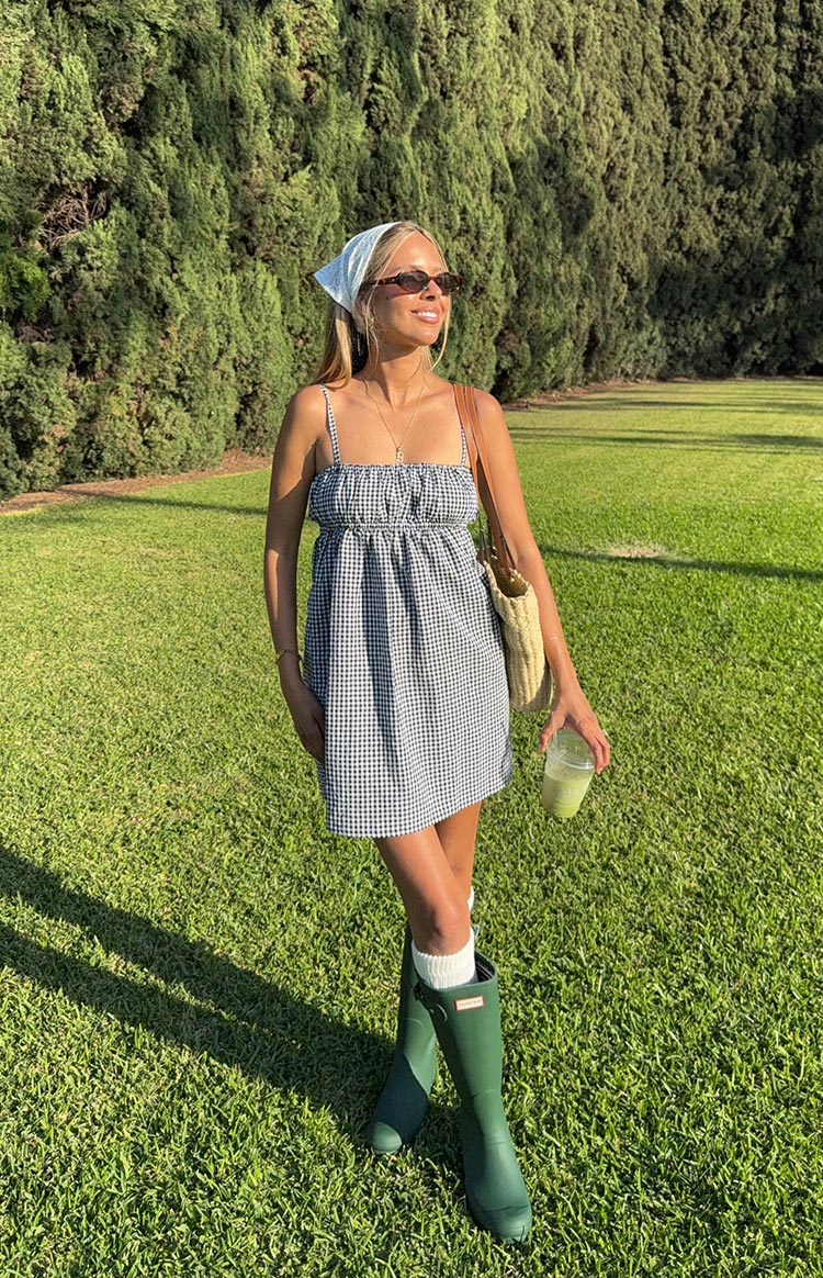 Black gingham mini dress with a smocked bodice, square neckline, and thin spaghetti straps