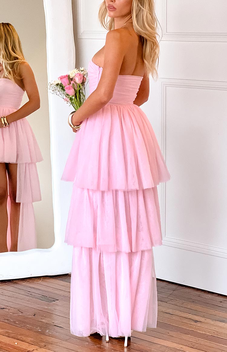 Side view of the pink high-low maxi dress with a full tiered tulle skirt and ruched strapless bodice