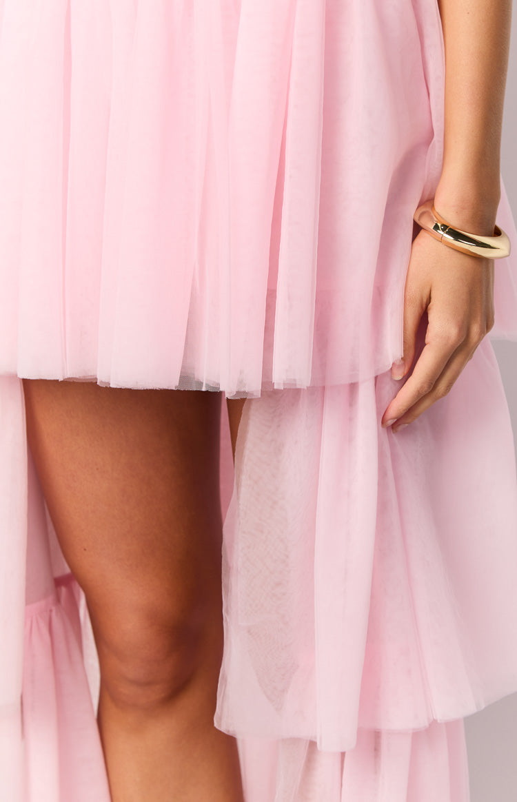 Close-up of the pink tulle high-low maxi dress showing the layered ruffled hem