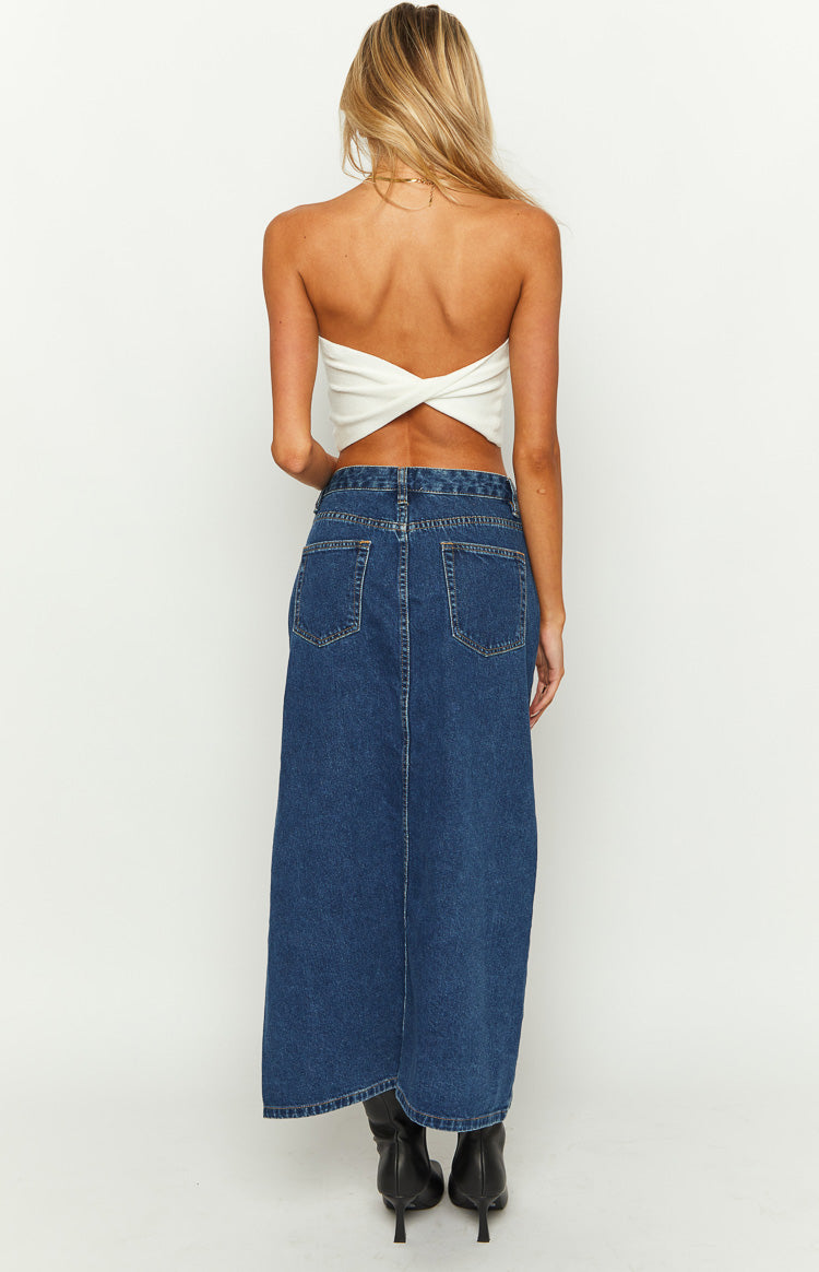 Rear view of the dark wash denim midi skirt with two patch pockets and a visible center seam