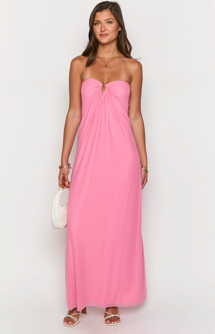 Pink strapless maxi dress with a gold ring detail at the center bust and a flowy skirt