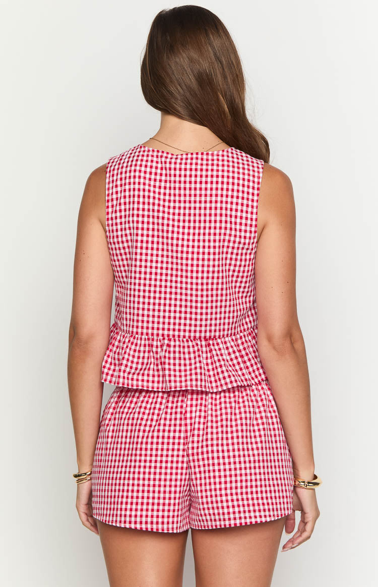Rear view of a red gingham sleeveless top with a gathered peplum hem
