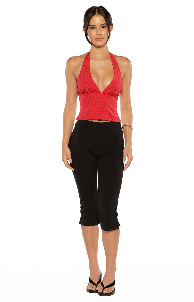 Red chiffon halter neck top with black polka dots, a deep V-neck, and a fitted peplum hem