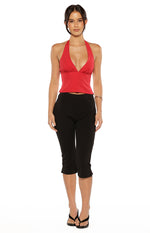 Red chiffon halter neck top with black polka dots, a deep V-neck, and a fitted peplum hem