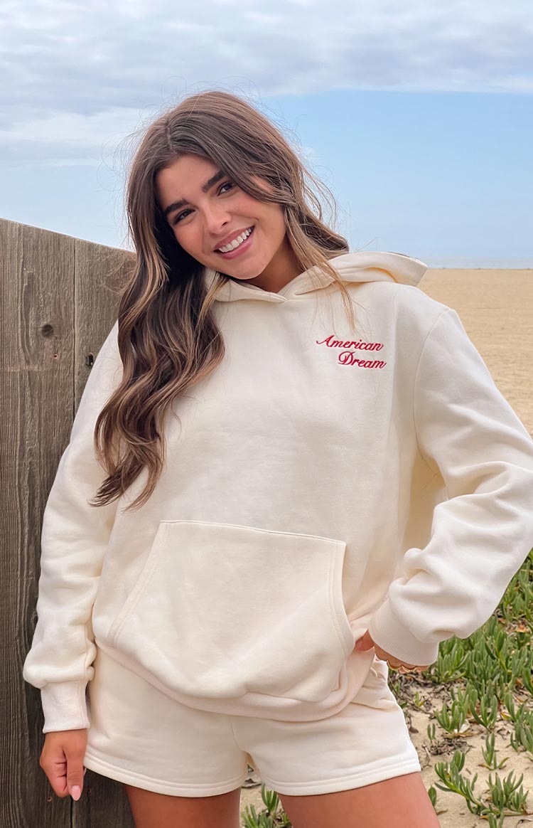 Cream fleece lounge shorts with an elasticated waistband, worn with a matching 'American Dream' hoodie